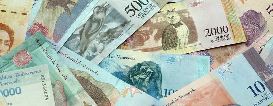 Venezuelan bolivar money banknotes pile on table. Venezuela bills of VES currency close up