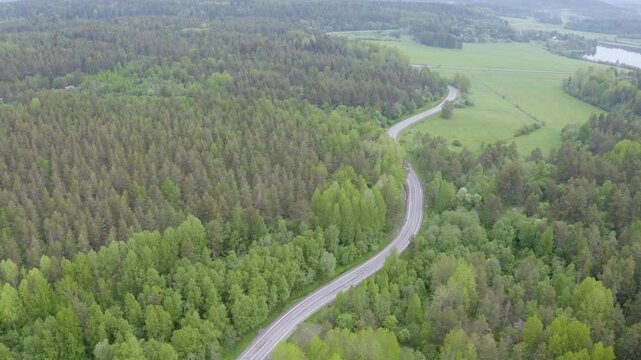 Aerial footage of Lahdenpohja - Sortavala road on misty summer day. Karelia, Russia.