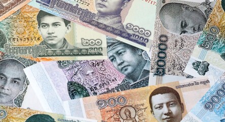 Cambodian riel money bills in pile on table. Cambodia KHR currency cash close up © Viktor