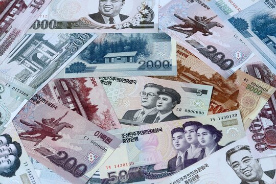 North Korean won money bills in pile on table. North Korea KPW currency cash close up