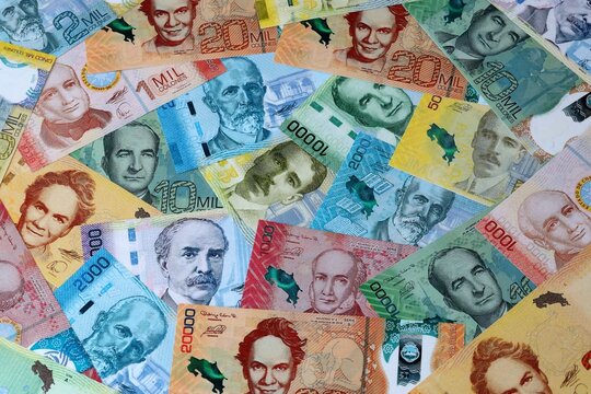 Costa Rican colon money bills in pile on table. Costa Rica CRC currency cash close up