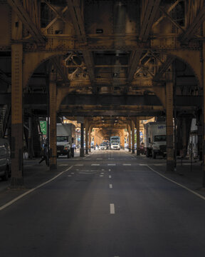 Chicago, United States - 15 September 2025: View of the iconic elevated train tracks with industrial steel girders and distant city traffic on a street in the downtown area.