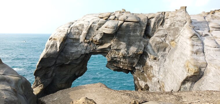 Natural sea arch rock formation resembling an elephant trunk