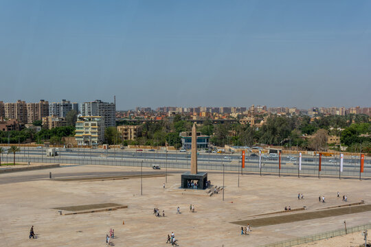 Giza, Egypt - 16 May 2026: View of the Grand Egyptian Museum plaza featuring the Hanging Obelisk with visitors walking under a clear blue sky.