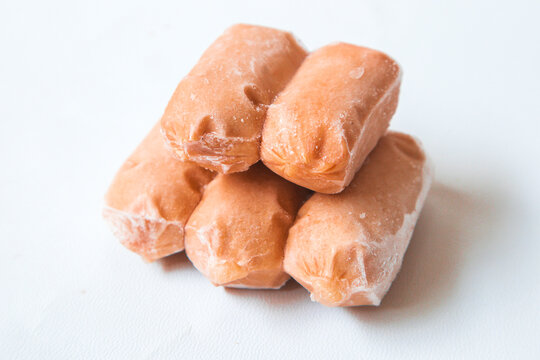 Mini frozen sausage beef meat isolated on white background. Bite-sized smoked sausages, hot dogs. Also called cocktail franks or cocktail weiner