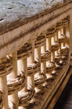 Salamanca, Spain - 29 November 2025: View of the intricate stone balustrade at the Casa de las Conchas, showing detailed Gothic and Renaissance carvings and weathered textures.