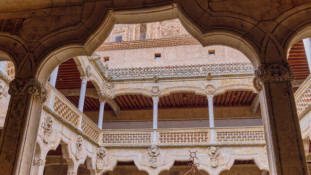 Salamanca, Spain - 29 November 2025: View of the ornate inner courtyard of the Casa de las Conchas with its Plateresque stone arches and intricate carvings.
