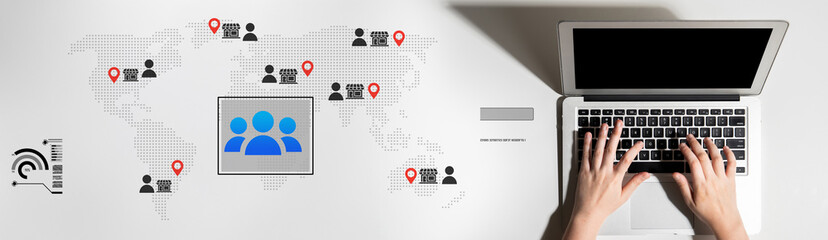 Fototapeta premium A hands-on laptop photo featuring a world map with people icons and location markers, highlighting themes of global communication and digital connectivity in modern workspaces. Cyphers