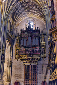 Plasencia, Spain - 03 December 2025: View of the ornate pipe organ and intricate vaulted ceiling inside the Catedral Nueva de Plasencia.