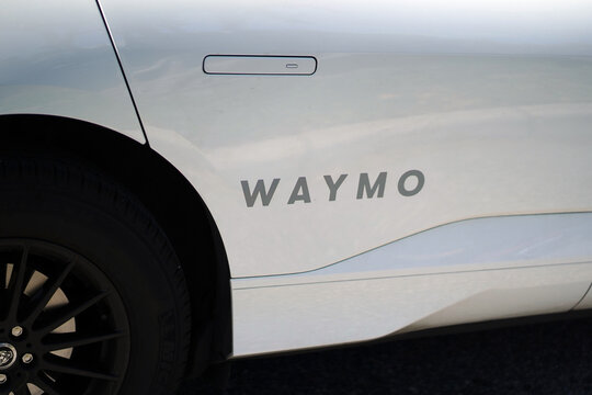 A Waymo autonomous vehicle drives on a sunny street in Florida with rooftop sensors and self driving technology visible in Orlando, Florida on April 11, 2026.