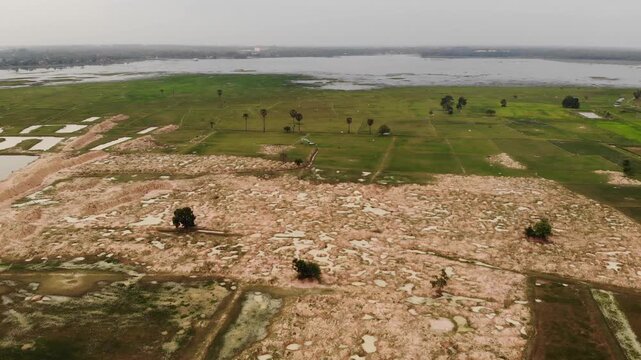 Aerial View of Dredging topsoil at wetland  and green grass field Construction Site in Surin, northeastern Thailand.