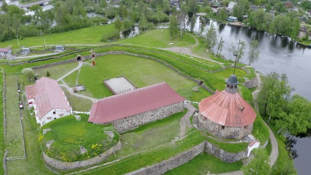 Tilt up aerial footage of Korela fortress on cloudy summer day. Priozersk, Leningrad Oblast, Russia.