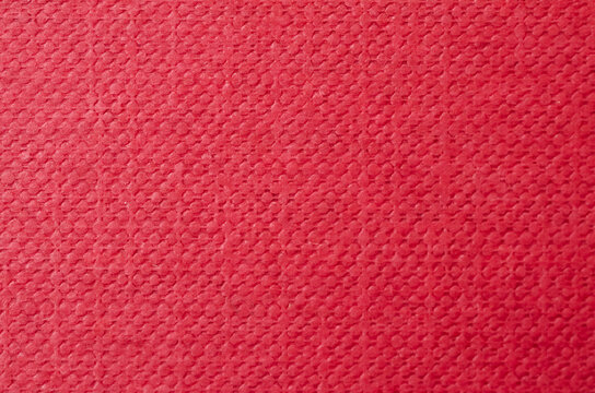 Vibrant red textured background with embossed geometric dot pattern