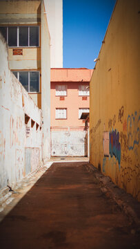 Alleyways contrast with the gray ochres of the city.