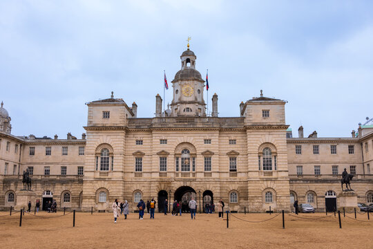 London, United Kingdom - 12 May 2025: View of the historic Horse Guards building with its central clock tower and people walking across the parade ground in London.