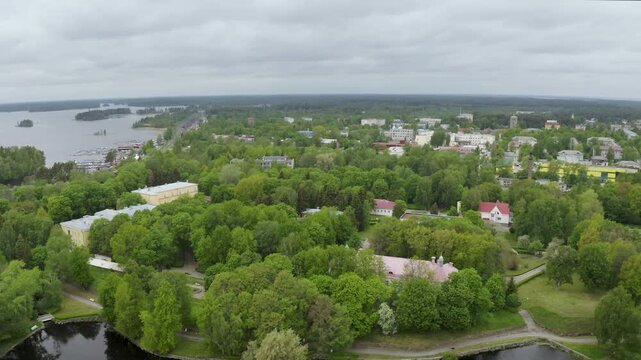 Backward reveal aerial shot of Korela fortress on cloudy summer day. Priozersk, Leningrad Oblast, Russia.
