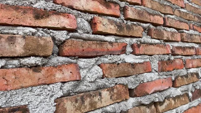 Close up of ancient red brick wall texture with mortar