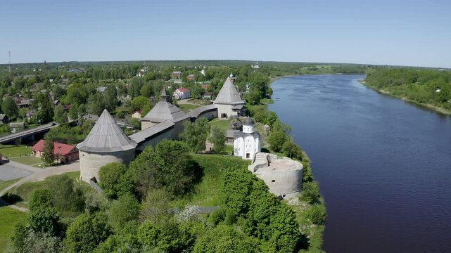 Sliding aerial shot of Ladoga fortress and Volkhov river on sunny summer day. Staraya Ladoga, Leningrad Oblast, Russia.