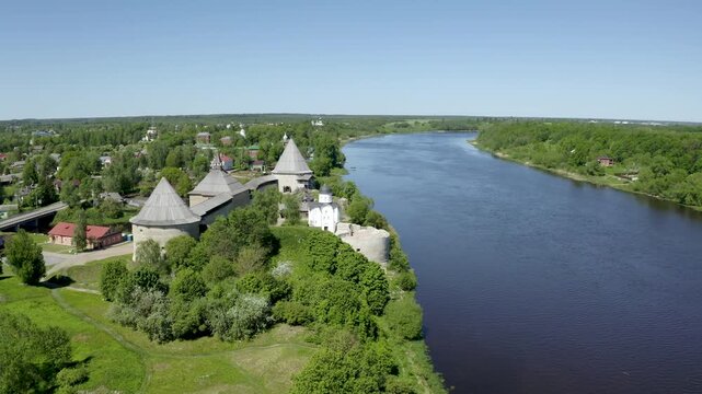 Forward reveal aerial shot of Ladoga fortress and Volkhov river on sunny summer day. Staraya Ladoga, Leningrad Oblast, Russia.