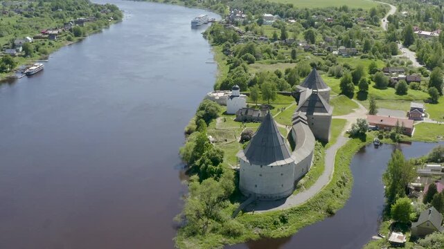 Tilt up aerial shot of Ladoga fortress and Volkhov river on sunny summer day. Staraya Ladoga, Leningrad Oblast, Russia.
