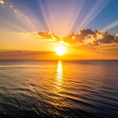 Fototapeta premium A serene ocean sunset with vibrant colors and sun rays
