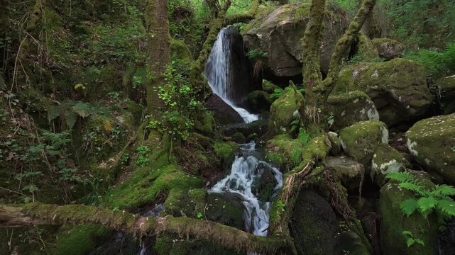 Cascada de Santo Estevo do Ermo Waterfall Flowing In Tropical Mountains Of Barreiros in Galicia, Spain. Sideways Shot