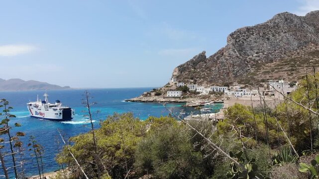 Aerial Approach to Levanzo Island Harbor in Sicily with Ferry In Summer