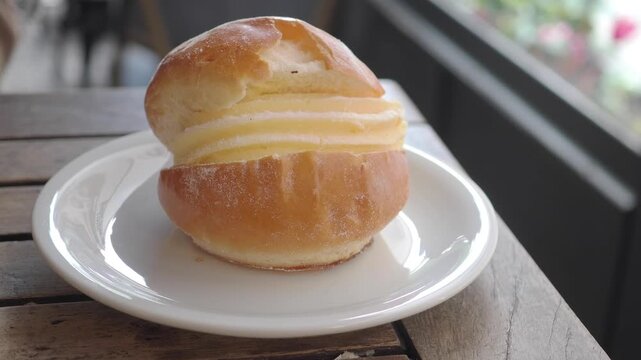 Fresh cream bun on a table with natural light