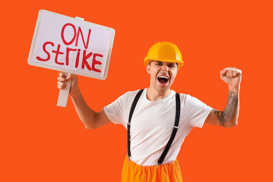 Protesting firefighter holding placard with text ON STRIKE against orange background