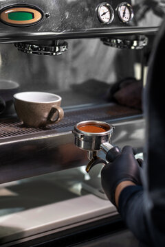 Perfectly tamped coffee puck in portafilter near machine
