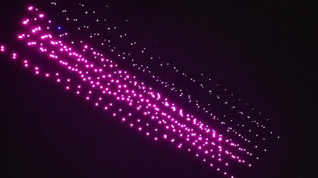 A swarm of drones performing at night.