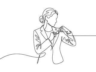 Fototapeta premium Woman in business suit adjusting collar and lapel with focus and concentration while preparing herself