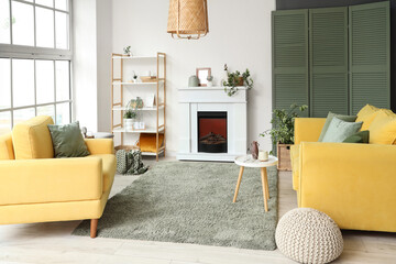 Fototapeta premium Interior of living room with electric fireplace, shelf unit and houseplants