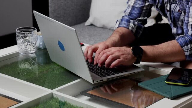 Freelancer working on laptop at home office to maintain productivity and focus while managing tasks remotely