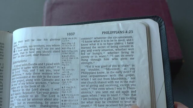 Holy Bible open up to the book of Philippians of the new testament, zooming into Chapter 4 verse 13 on doing everything through Christ. New International Vers