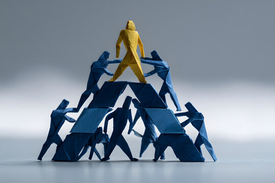 Team forming a structured origami triangle with the leader at the top empowering the base, modern symbolic structure