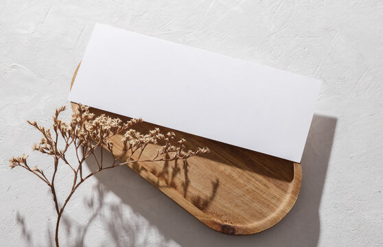 White blank flyer mockup in wooden tray on concrete background