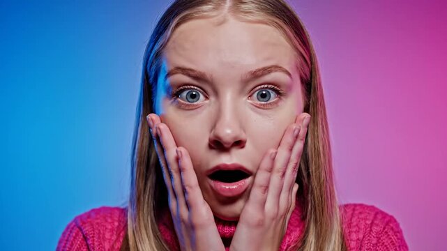 Shocked young woman gasping with hands on face against neon background