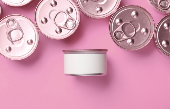 Cans with canned pet food on pink background. Top view. Flat lay. Mockup