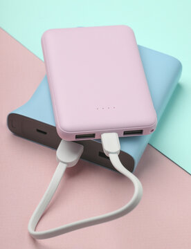 Two Plastic power banks on blue pink pastel background