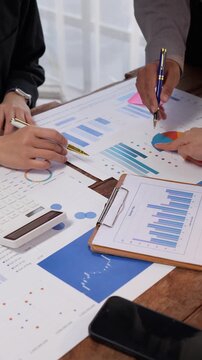 Business team analyzing financial data and marketing reports