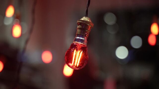 Decorative light bulbs with warm glow in evening atmosphere with bokeh background.