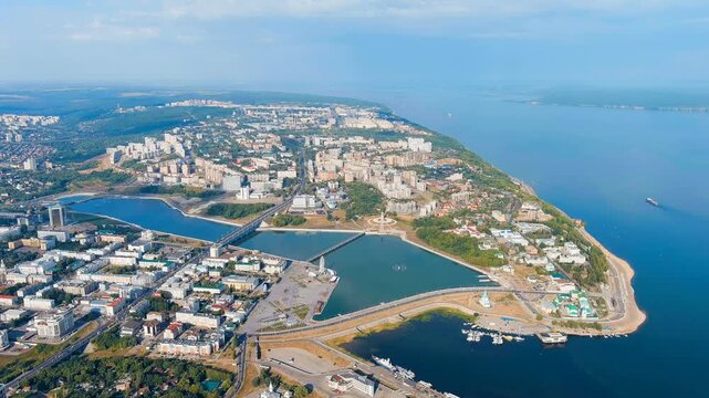 Cheboksary, Russia. Mother Patroness Monument, a 46-meter copper-clad figure with outstretched arms overlooking Cheboksary Bay and the Volga River, Drone footage under clear summer sky. Drone footage