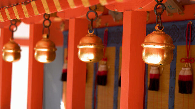 Traditional Golden Suzu Bells Hanging at a Japanese Shinto Shrine in Kyoto