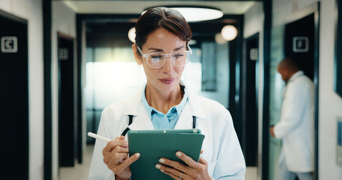 Medical, doctor or tablet with pen in hospital for clinical notes, digital prescription or review. Professional, mature woman or health app with stylus for insurance records, test results and glasses