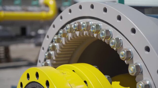 Close-up of large industrial venturi tube with flanged end, with several bolt holes around the circumference. Equipment maintenance manufacturing plant factory oil and gas metal pipe. Petrochemical.