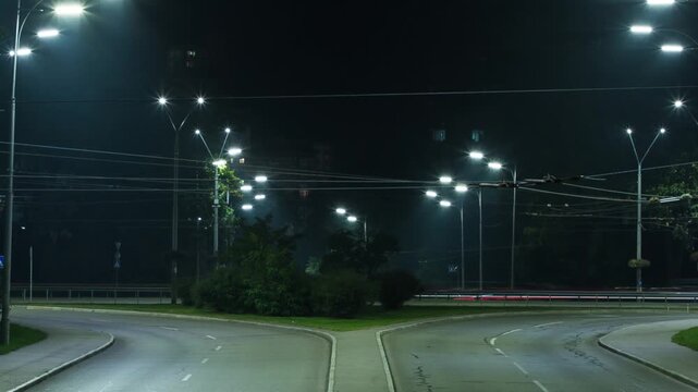 Timelapse of car headlights on the road at night, glare of headlights on the road in the night city, light of streetlights