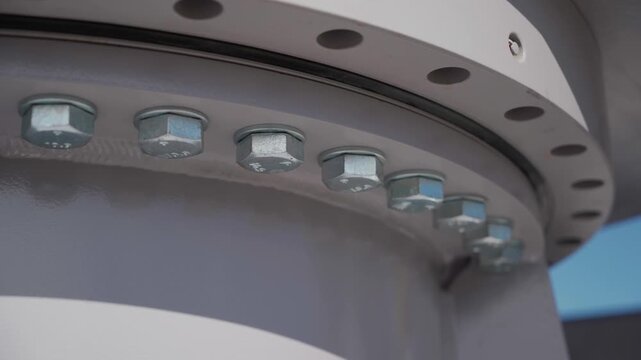 Close-up of large industrial venturi tube with flanged end, with several bolt holes around the circumference. Equipment maintenance manufacturing plant factory oil and gas metal pipe. Petrochemical.