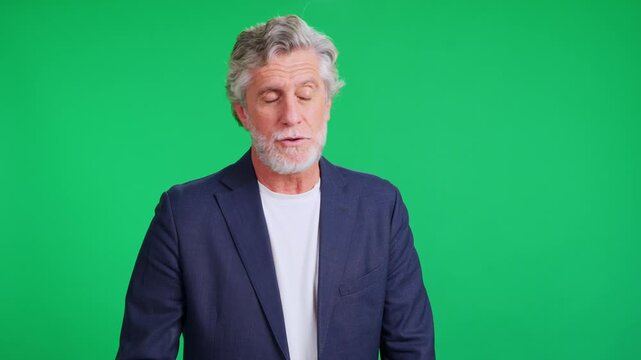 Mature businessman reprimanding the team on a green screen
