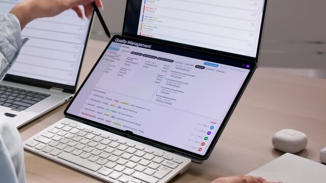 Quality Manager Reviewing Software Dashboard For Corrective Actions